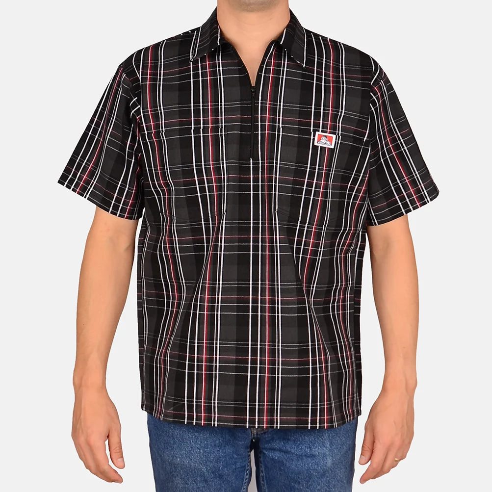 Model wearing a Ben Davis black red plaid short-sleeve half-zip shirt with chest logo front view