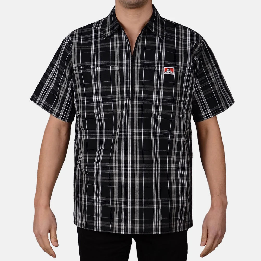 Model wearing a Ben Davis black white plaid short-sleeve half-zip shirt with chest logo front view