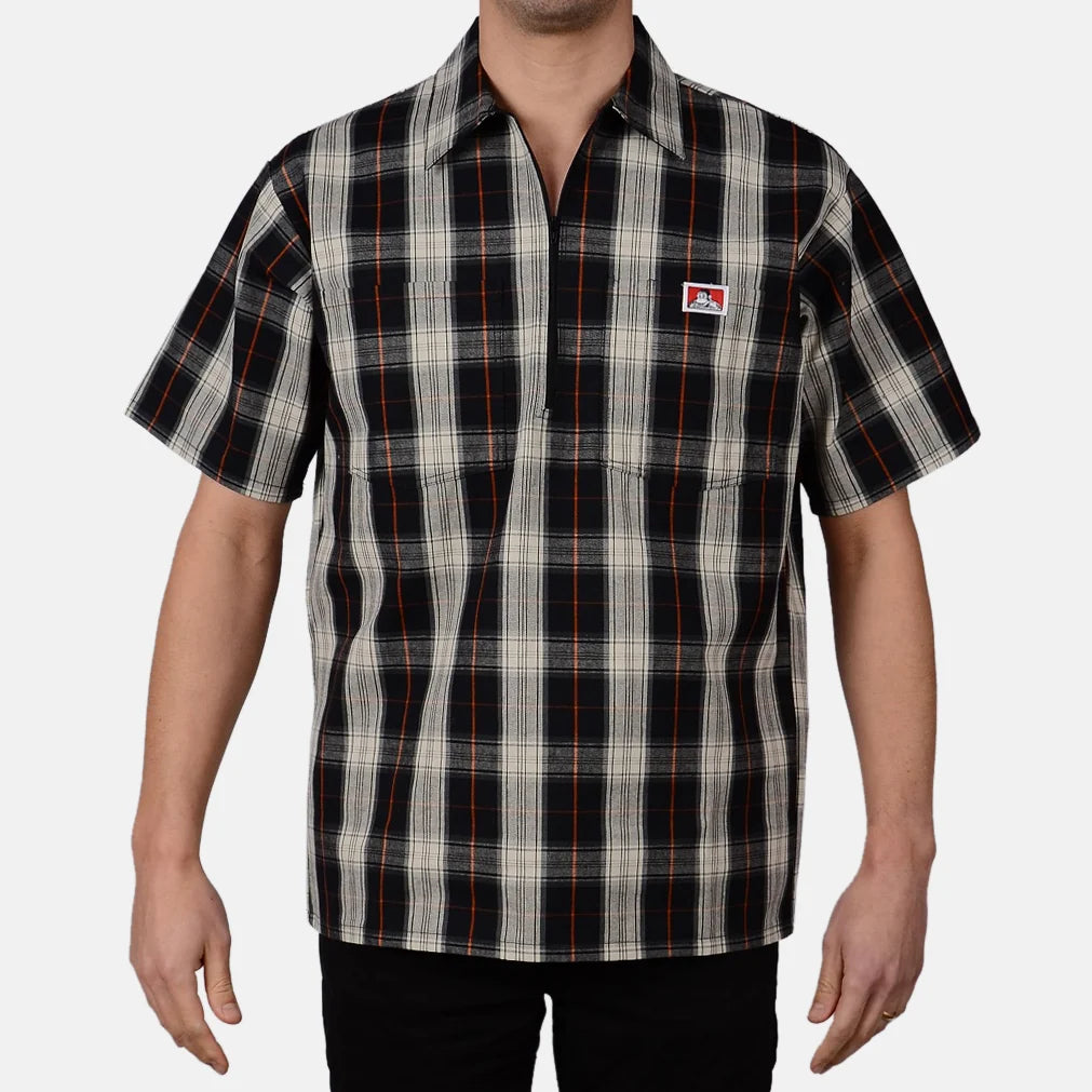 Model wearing a Ben Davis black cream plaid short-sleeve half-zip shirt with chest logo front view