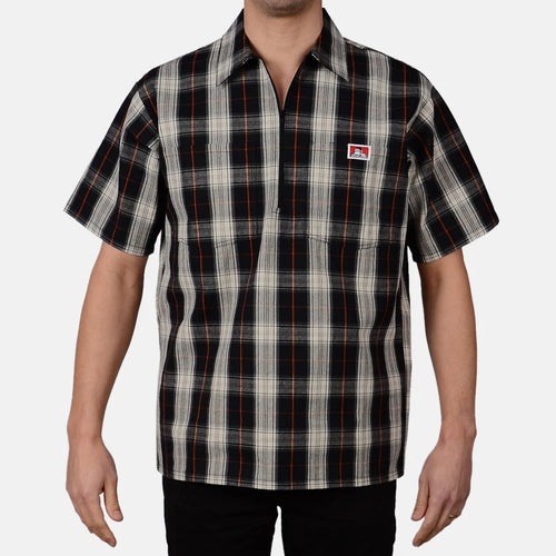 Model wearing a Ben Davis black cream plaid short-sleeve half-zip shirt with chest logo front view