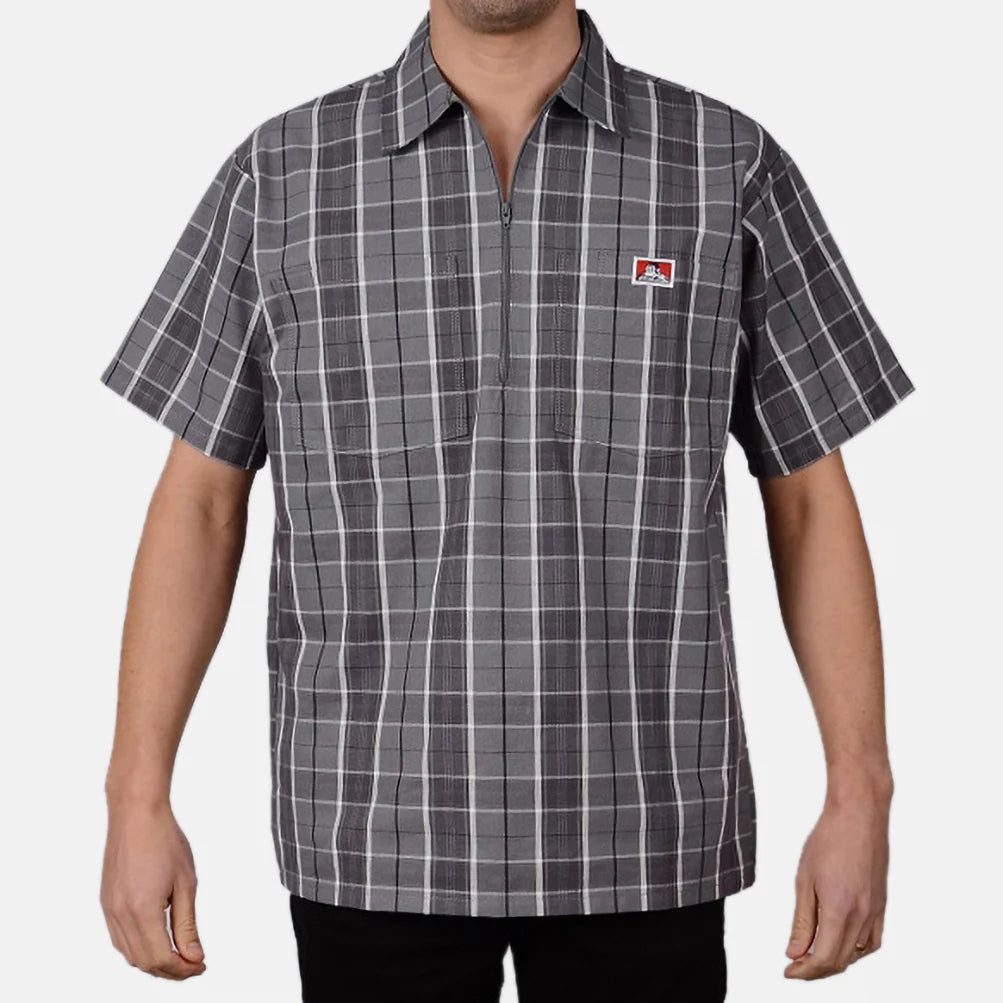 Model wearing a Ben Davis grey black plaid short-sleeve half-zip shirt with chest logo front view