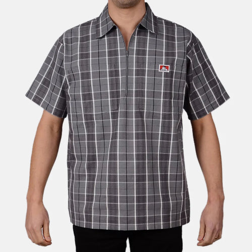 Model wearing a Ben Davis grey black plaid short-sleeve half-zip shirt with chest logo front view