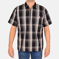 Model wearing a Ben Davis navy grey plaid short-sleeve half-zip shirt with chest logo front view